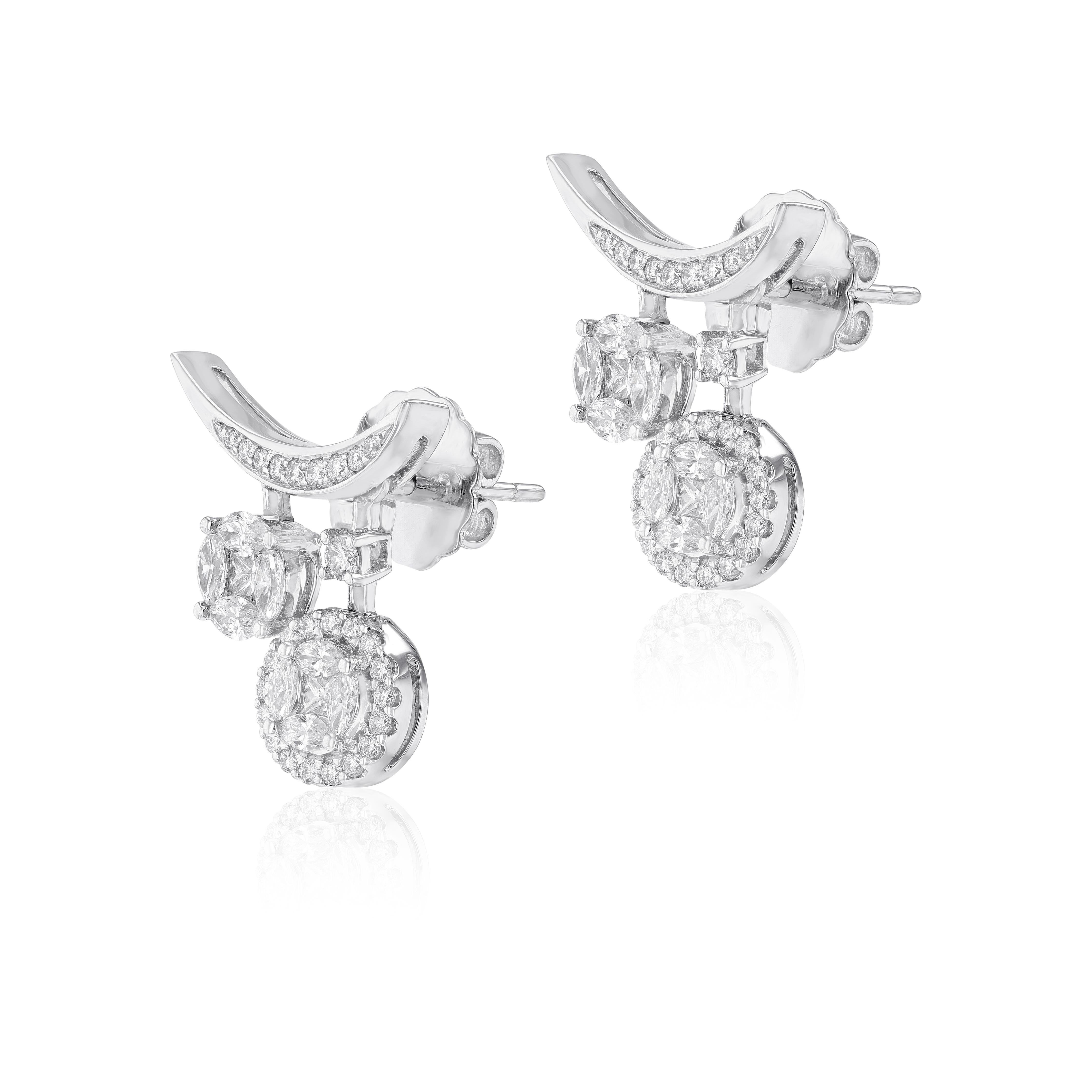 A petite yet powerful incarnation of crescent, the 18 karat white gold earring is illuminated by round cut diamonds that is given vibrant accents by their delicate wings. Suspended from each side 2 exquisite small to medium round shape diamonds that