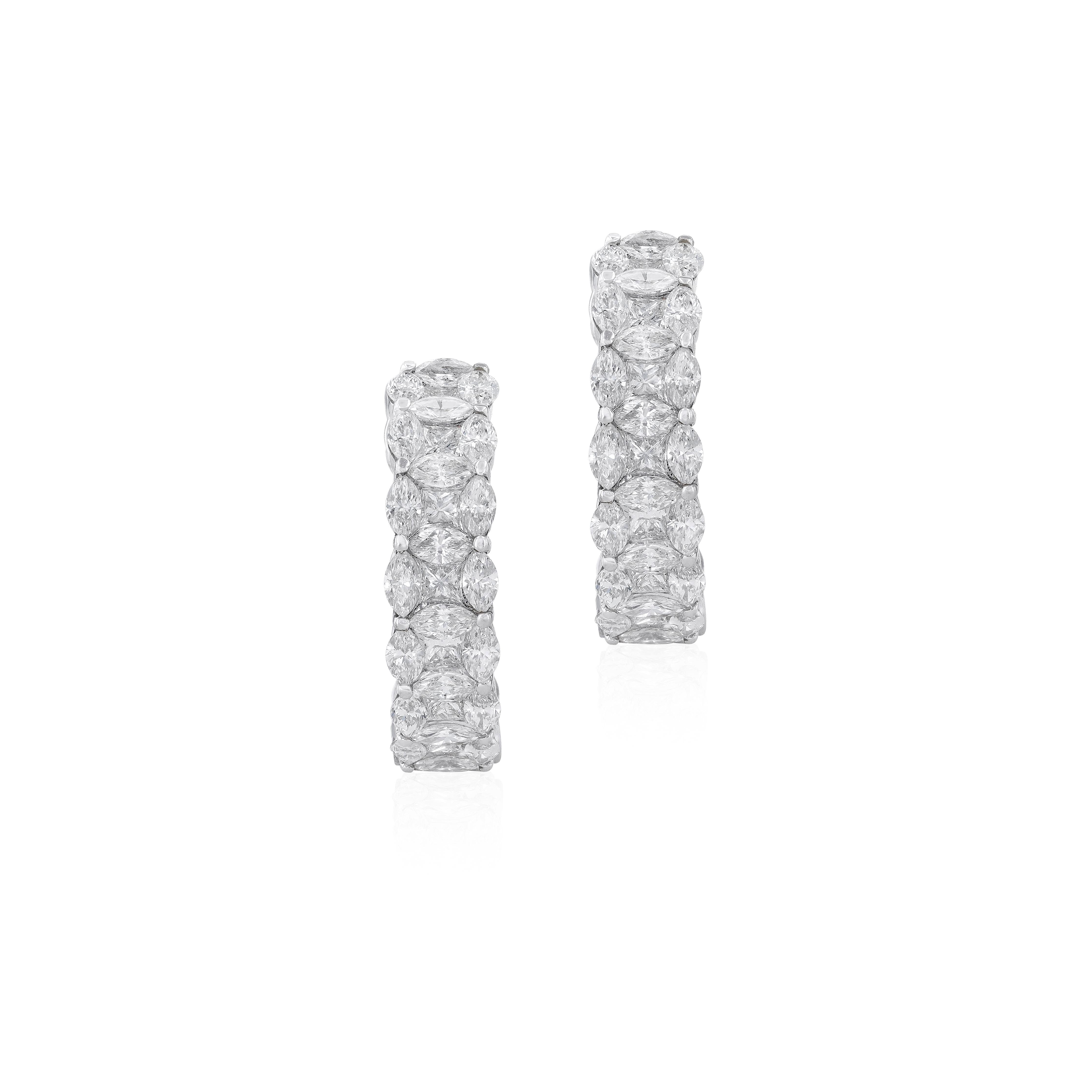 A fascinating twist on the classic hoop earring, the impactful design of this 18 karat white gold earrings features dynamic spirals set with round diamonds. Bringing a  diamond sparkle to each ear, our hoop earrings create a dramatic
