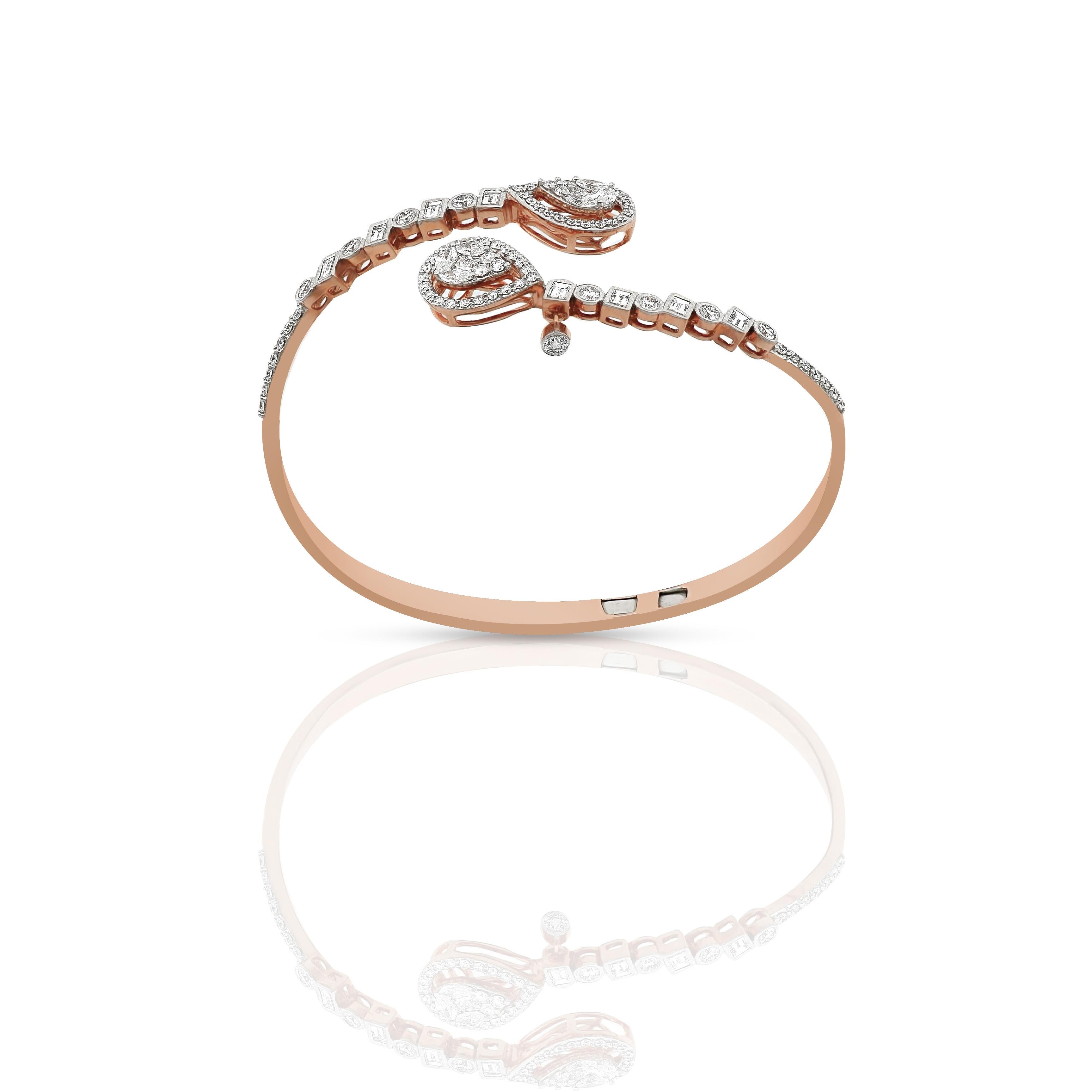 Amwaj flexible wraparound diamond bangle in 18 karat rose gold features a delicate row of round and baguette cut diamonds that lead the eye towards 2 groups of marquise, princess and round diamonds forming 2 pear shapes.
18 Karat Rose Gold
Diamond