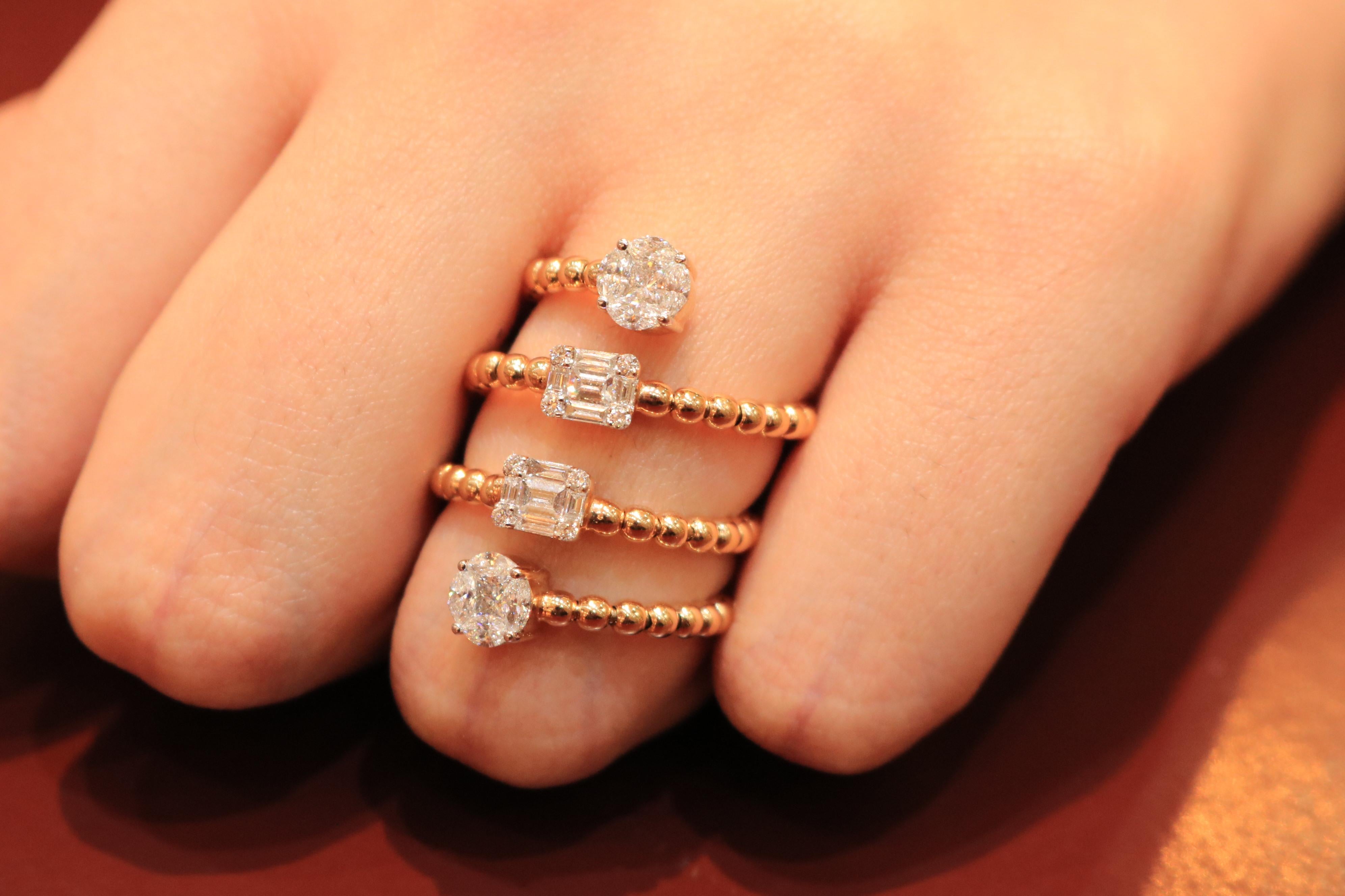 Unique, artistic, minimal statement 18K rose gold ring with round and baguette diamonds by Amwaj Jewellery. 
Find the simplicity and luxury by wearing this rose gold beaded spiral ring with diamonds. This ring is composed of layers with round shape
