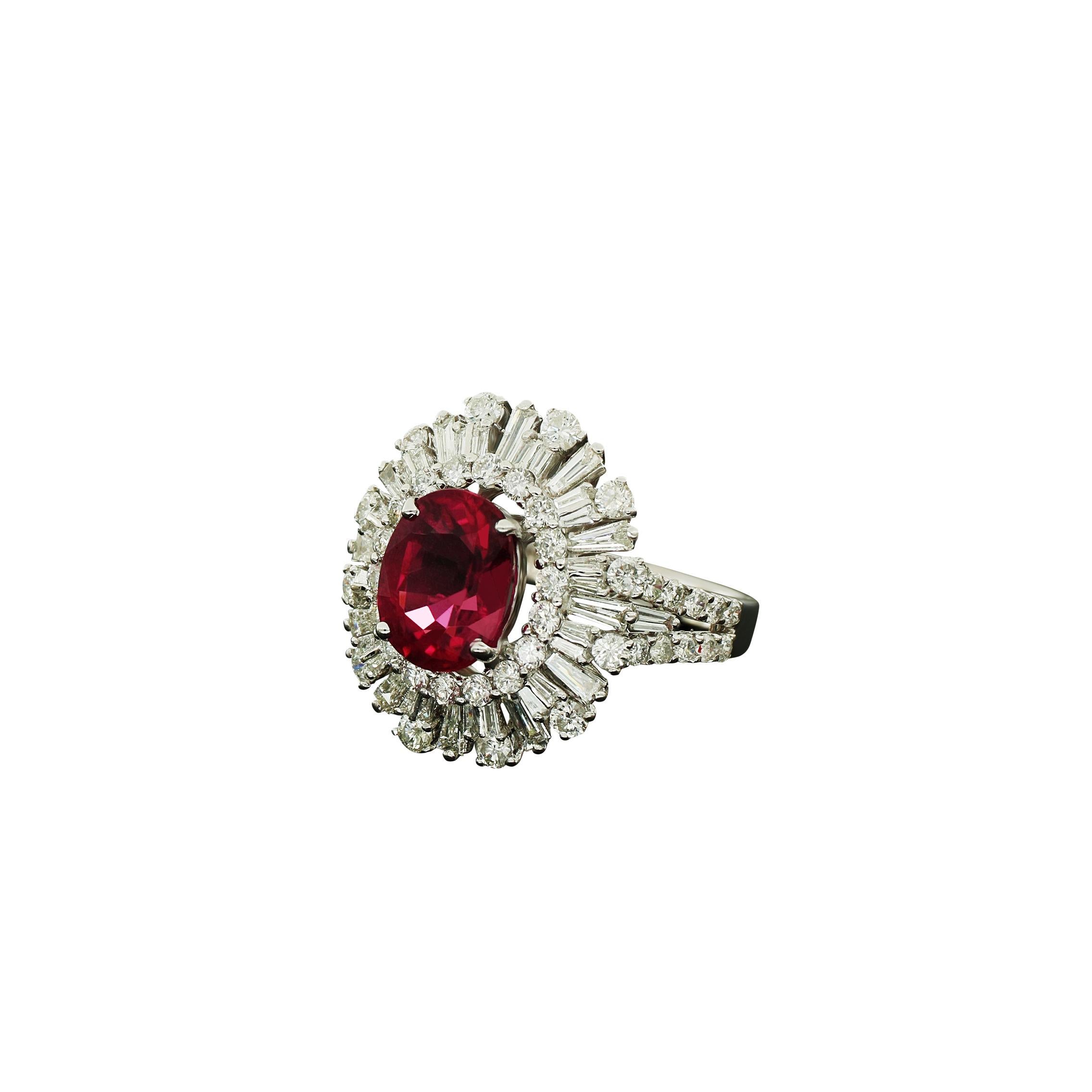 Classy and elegant 18K white Gold Amwaj Ring with Diamonds. Exquisite decorative detailing makes this significant ring a true standout. Featuring center Ruby nestled beside shimmering small Round and Baguette shape diamonds, this beautiful Ring