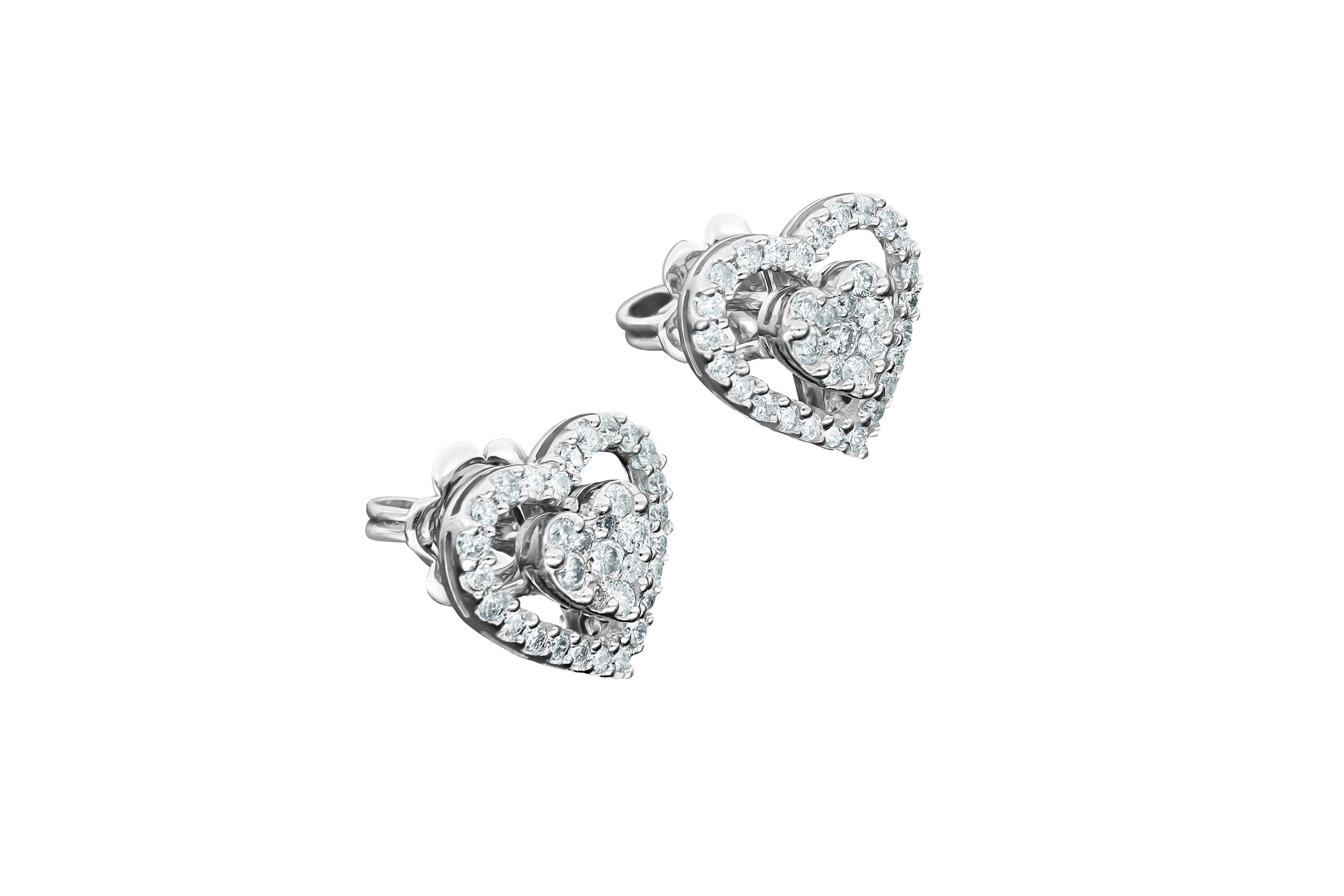  Classy, romantic 18K White Gold Amwaj earring with Diamonds. For the look that epitomizes love, this round shape Diamond earring each feature a symbolic heart shape surrounded by a halo of shimmering round shape Diamonds. In the heart of our