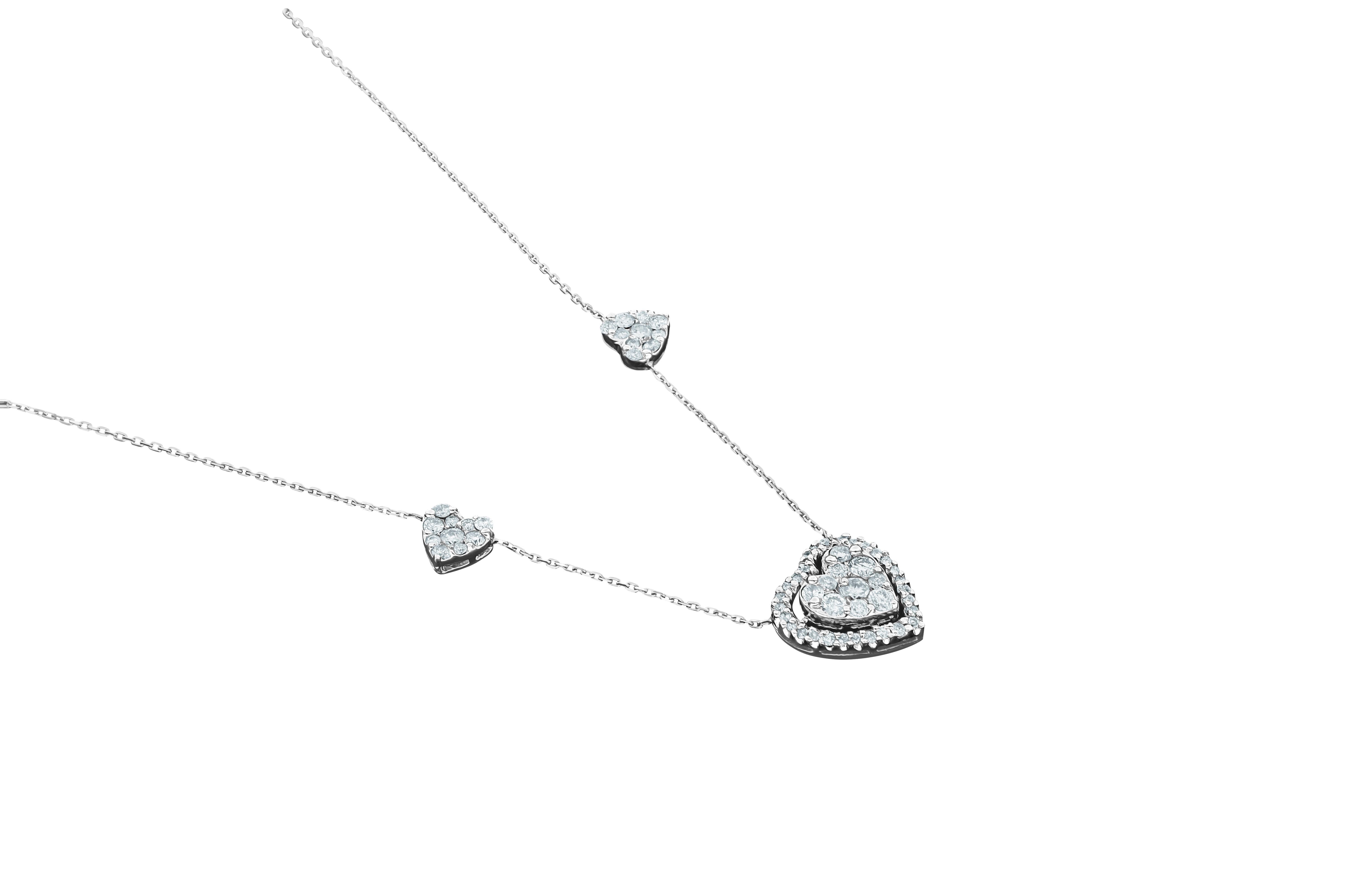 Scintillating, stylish 18K White Gold Amwaj Pendant with diamonds. This unique Pendant is cut to a high level of quality with round shape Diamonds making an illusion of a heart. The round shape Diamond halo, around the center heart, is stunning in