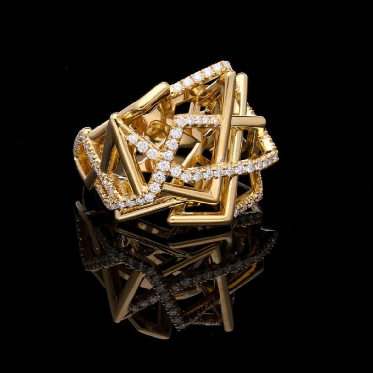 A beautiful gold and diamond Disorient ring by Amy Burton, the striking yellow gold ring of asymmetric architectural design with openwork geometric shapes formed by three dimensional angular woven gold, random sections of which have been highlighted
