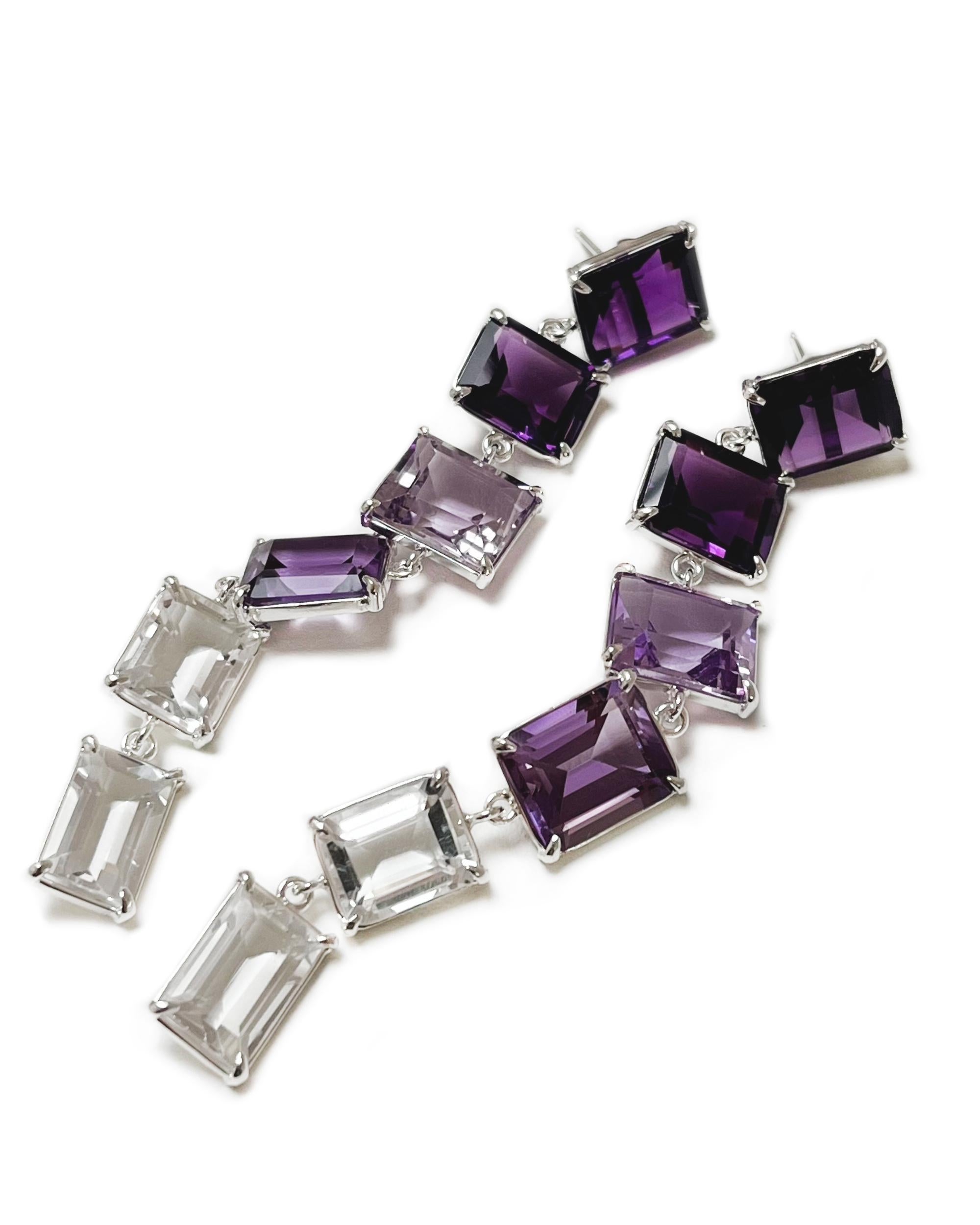 Intention: Ombre away

Design: The Amy earrings are a sweet violet cloud of dangling amethyst and white topaz set both vertically and horizontally. Between the movement of each gemstone, and the gradient colors, you too will feel like you could