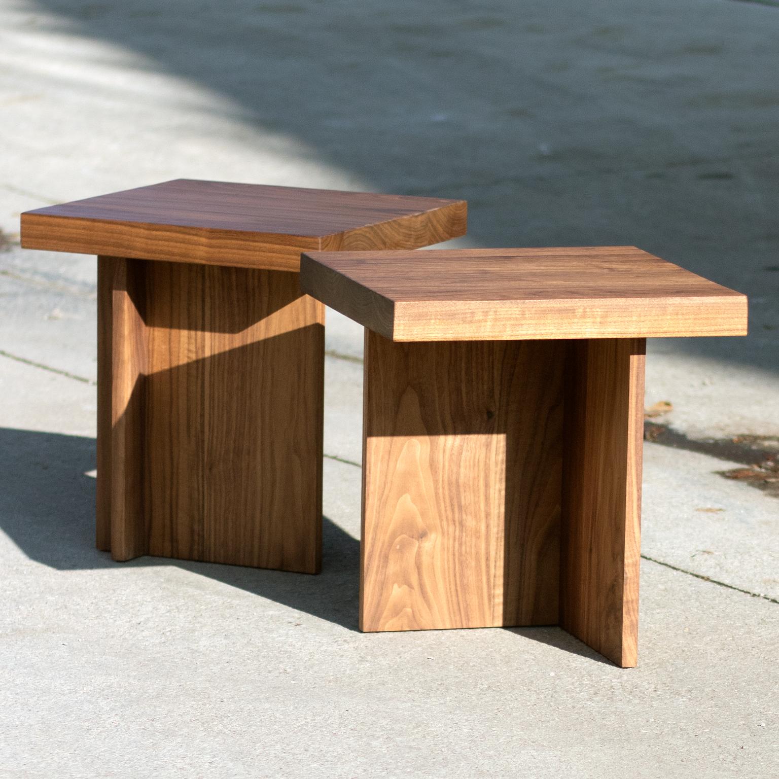 This is a solid walnut side table or small stool. The profile is asymmetrical and architectural while celebrating the natural wood elements. 

Customizable.