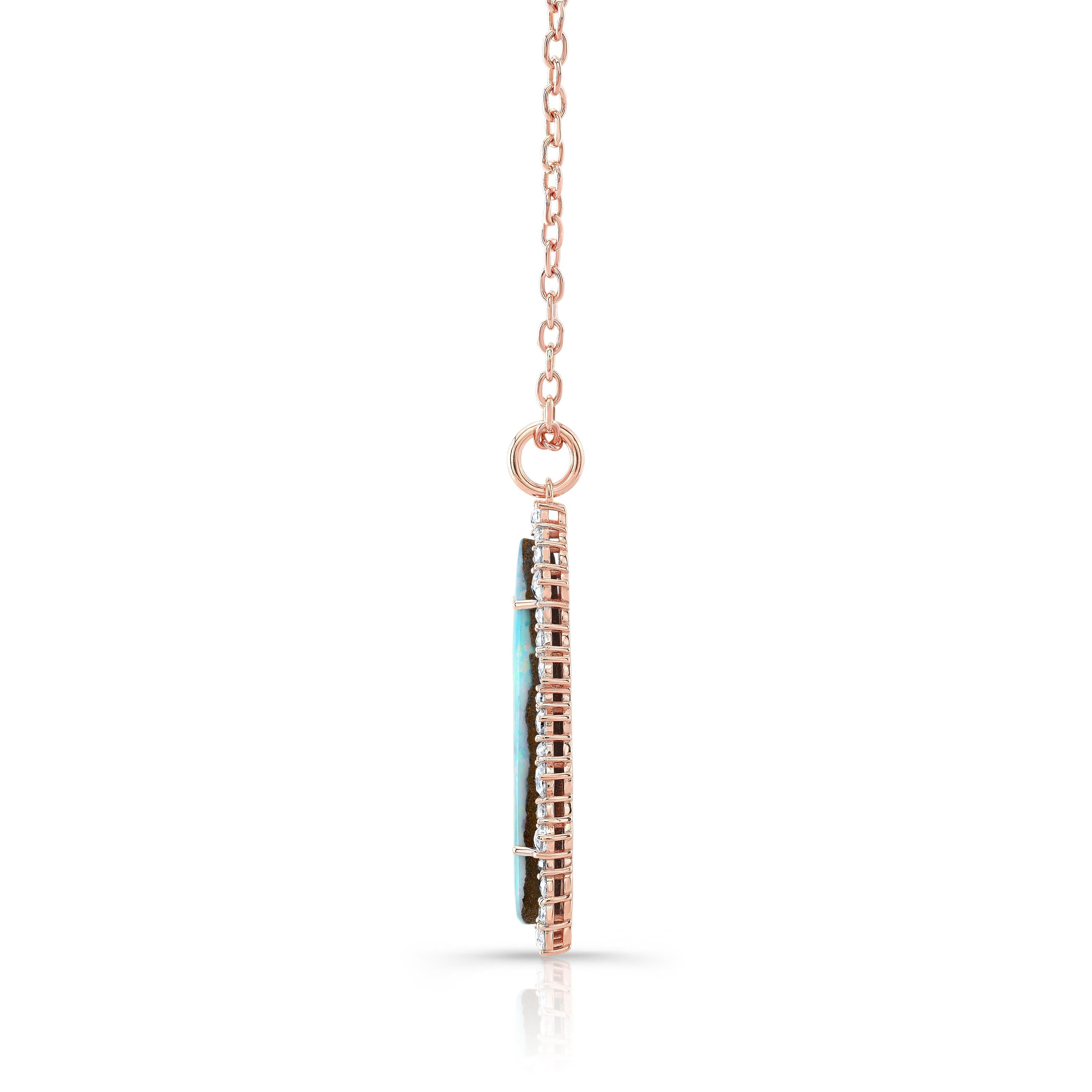 Amy Y's boulder opal and diamond contemporary pendant necklace is a one-of-a-kind piece for all occasions.  Set superbly in 18K-rose gold, is this primarily blue,  green and hints of pink-colored boulder opal,  generously surrounded by a row of