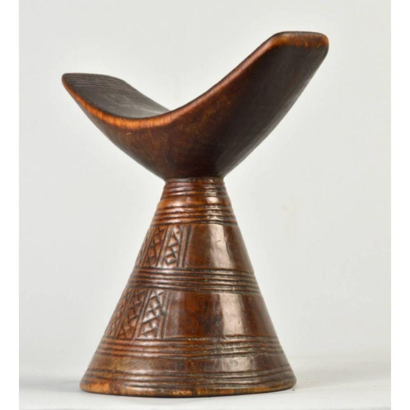 Amyas Naegele Jimma Headrest II in Wood

Jimma headrest with a lovely patina from handling and years of use. There is a handmade incised decoration on the support. This base was turned on a lathe.

Additional Information
Primary Materials: