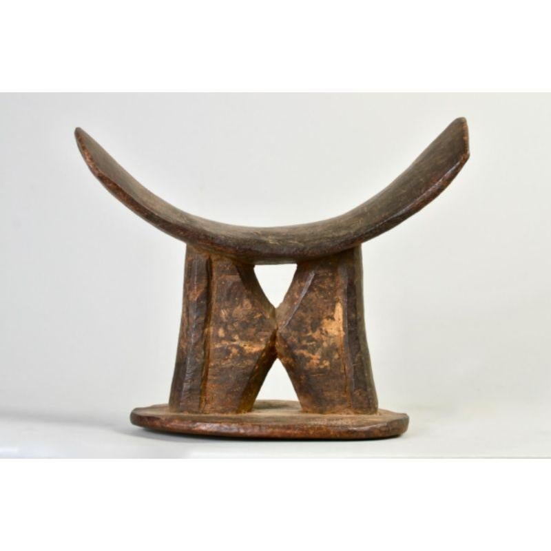 Amyas Naegele large Dogon/tellem headrest in wood.

Large Dogon headrest with hourglass triangular windows ca. 16th century or earlier. According to the Met, “What little is known of Tellem society is based on the contents of remote chambers of