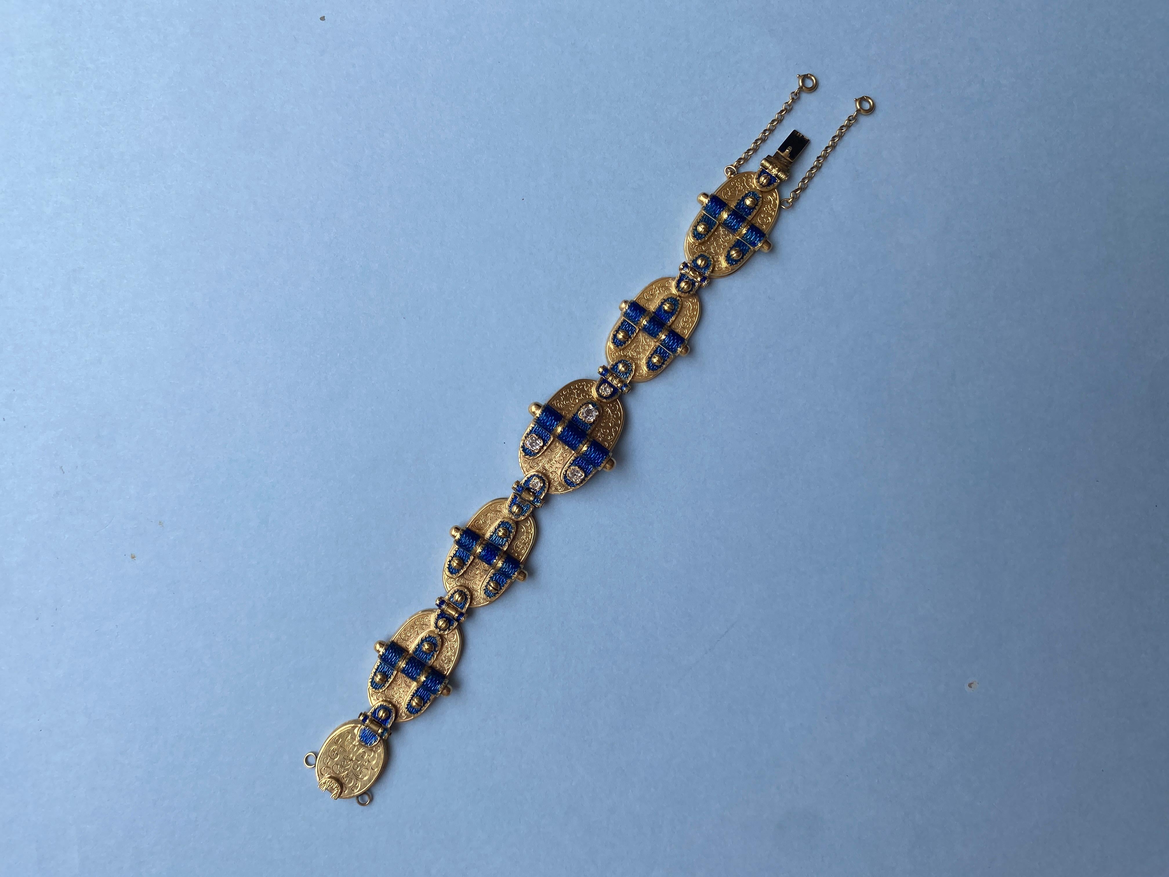 A 14 carat yellow gold bracelet with large oval links with simulated hinge decorations consisting of three juxtaposed elements each with translucent blue enamel and the denter link is decorated with five old cut diamonds (app. 1.5 carats). The lock