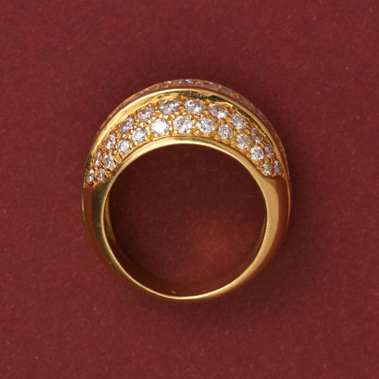 An 18 carat gold ring set with a vertical of 17 baguette cut diamonds around which are 46 brilliant cut diamonds (app. 3.2 carats), poinçon de maître JC, France, circa 1980.

weight: 9.5 gram
ring size: 16.5 mm. / 6 US.