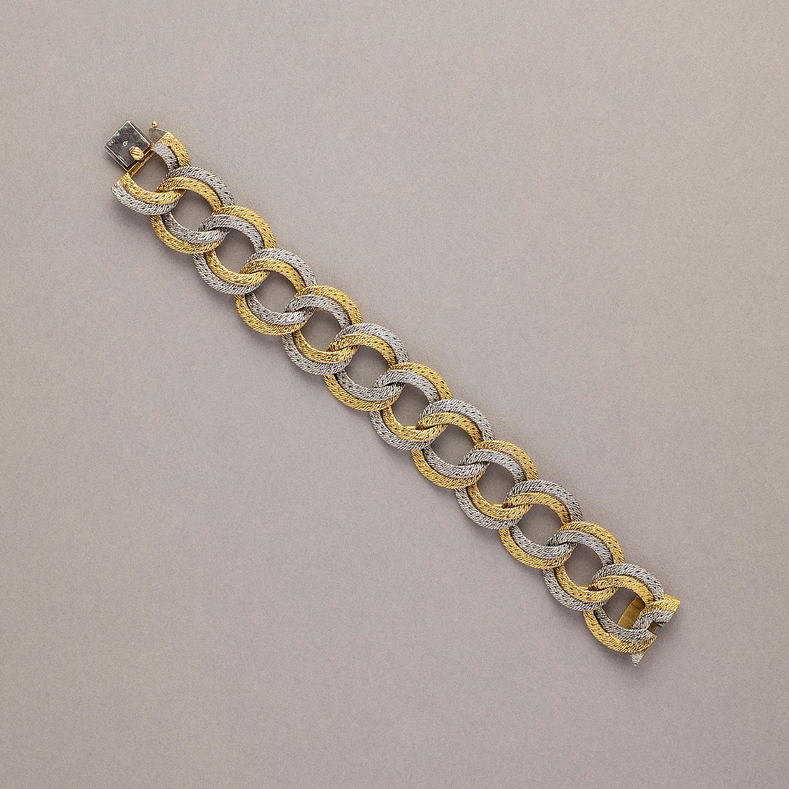 An 18 carat gold bi-color double link woven bracelet, marked: Georges Lenfant, circa 1970. 

weight: 71.53 grams
length: 19.5 cm
