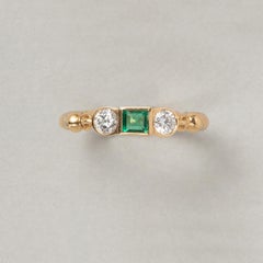 An 18 Carat Gold Cartier Three-Stone Ring with Diamond and Emerald