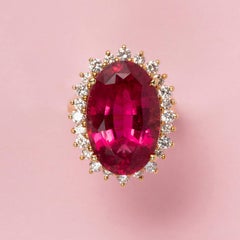 An 18 Carat Gold Cluster Ring with a Pink Tourmaline and a diamond entourage