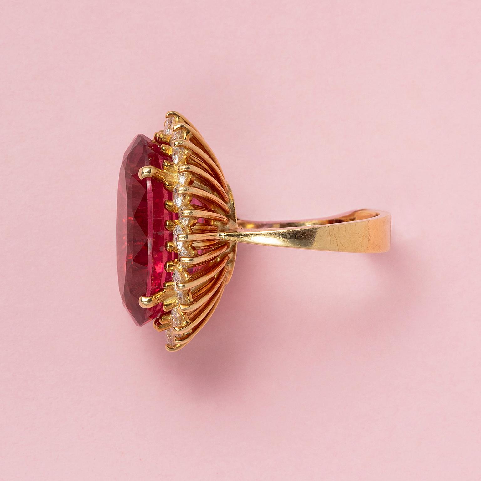 Oval Cut An 18 Carat Gold Cluster Ring with a Pink Tourmaline and a diamond entourage For Sale