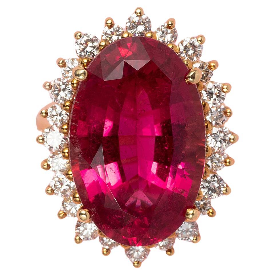 An 18 Carat Gold Cluster Ring with a Pink Tourmaline and a diamond entourage For Sale