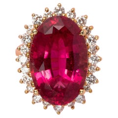 An 18 Carat Gold Cluster Ring with a Pink Tourmaline and a diamond entourage