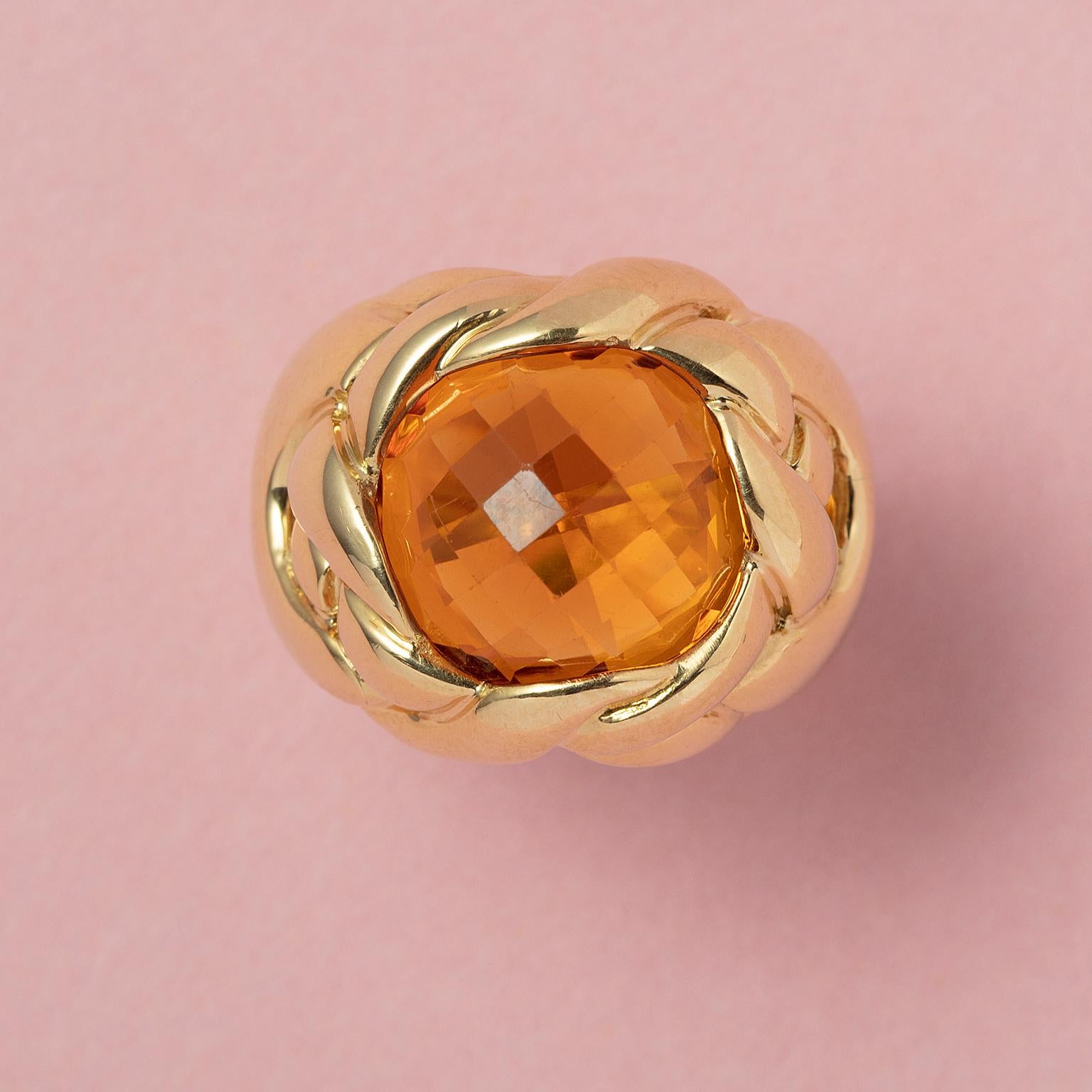 A large 18 carat yellow gold ring set with a large rounded square checkerboard cut honey coloured citrine in a setting of thick 'woven' gold wires,  signed Fred Paris.

weight: 19.57 grams
size: 18 mm / 7 3/4 US
width: 4.5 - 19 mm