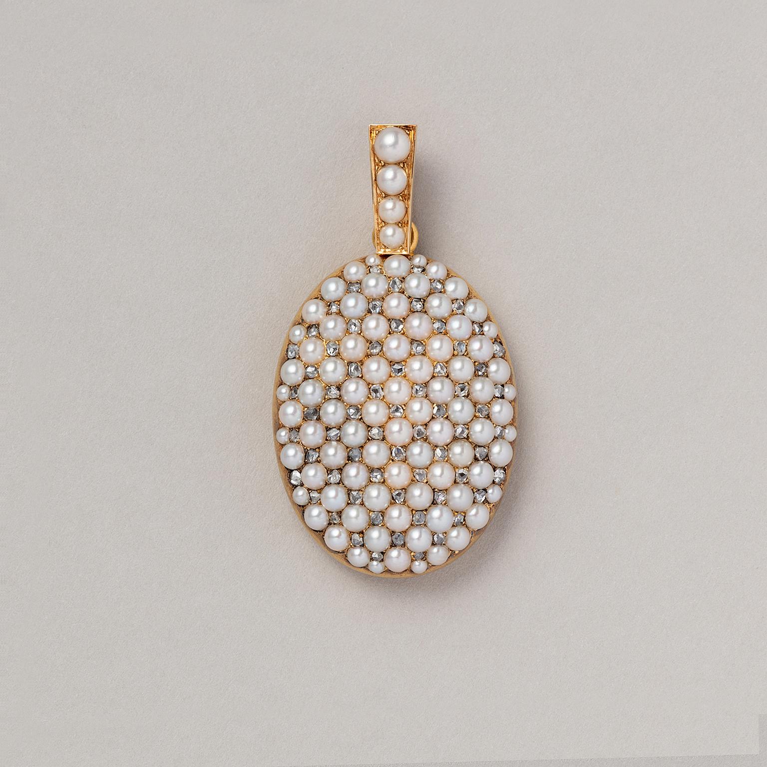 An 18 carat yellow gold locket with a grid of white half round pearls alternated with rose cut diamonds, and four halfround pearls on the bail descending in size  At the back is one removable glass, France, end 19th century.

weight: 25.66