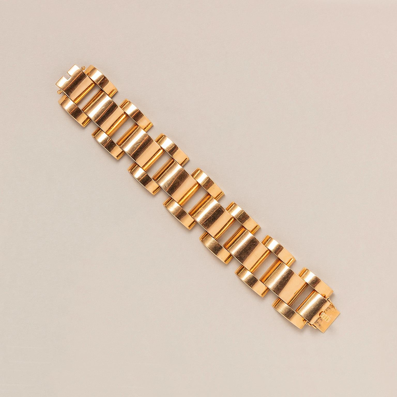 An 18 carat warm yellow gold tank bracelet with convex shapes with an invisible box lock and two safety clasps.
Period: Retro

Weight: 101 grams 
Length: 20 cm fits a medium to large wrist
Width: 3 cm