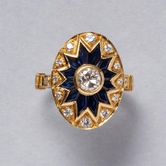 An 18 carat gold ring with diamond and sapphire