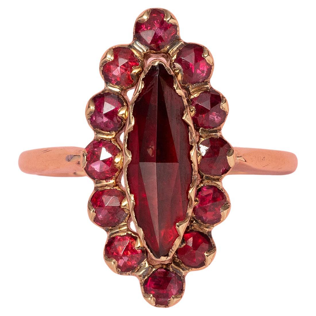 An 18 Carat Gold Ring with Garnets For Sale