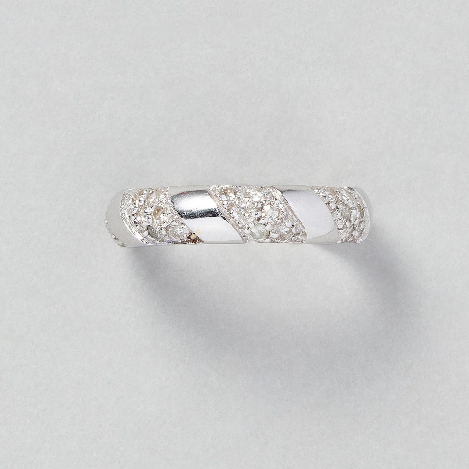 An 18 carat white gold band ring with five oblique bands pavé set with diamonds, like a cord is wrapped around the ring, marked with French gold mark and master mark.

weight: 4.22 g
size: 16.75 mm / 6 1/2 US
width 5 mm