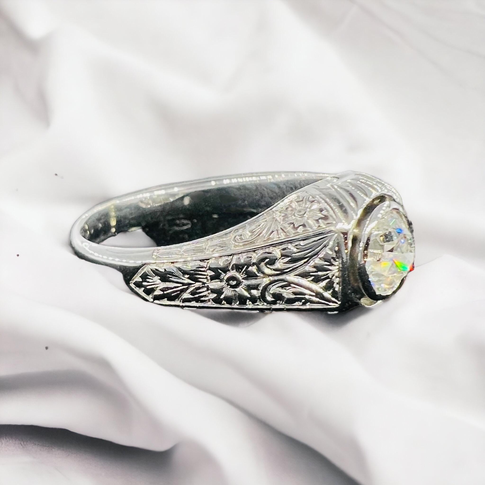 an 18 carat white gold ring set with a diamond
  old cut of around 1 carat , I estimate the purity this diamond Si1 and the color H
superb decorative carving work
work from the 1930s, Art Deco period
ring size: 62 or 9-3/4
total weight: 6.50