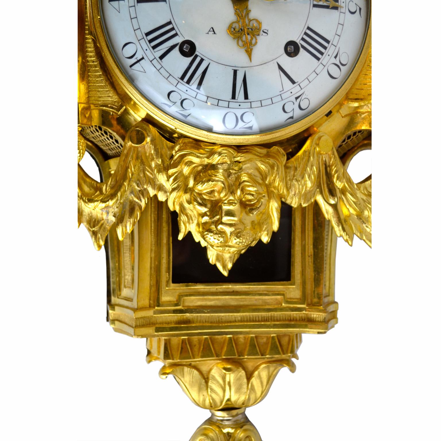 A period Louis XVI Cartel clock in original fire gilded bronze; the large white enamel dial with Roman and Arabic numerals and is signed Gilles Laine, who was an important 18th century French clockmaker. The dial is surmounted with a draped