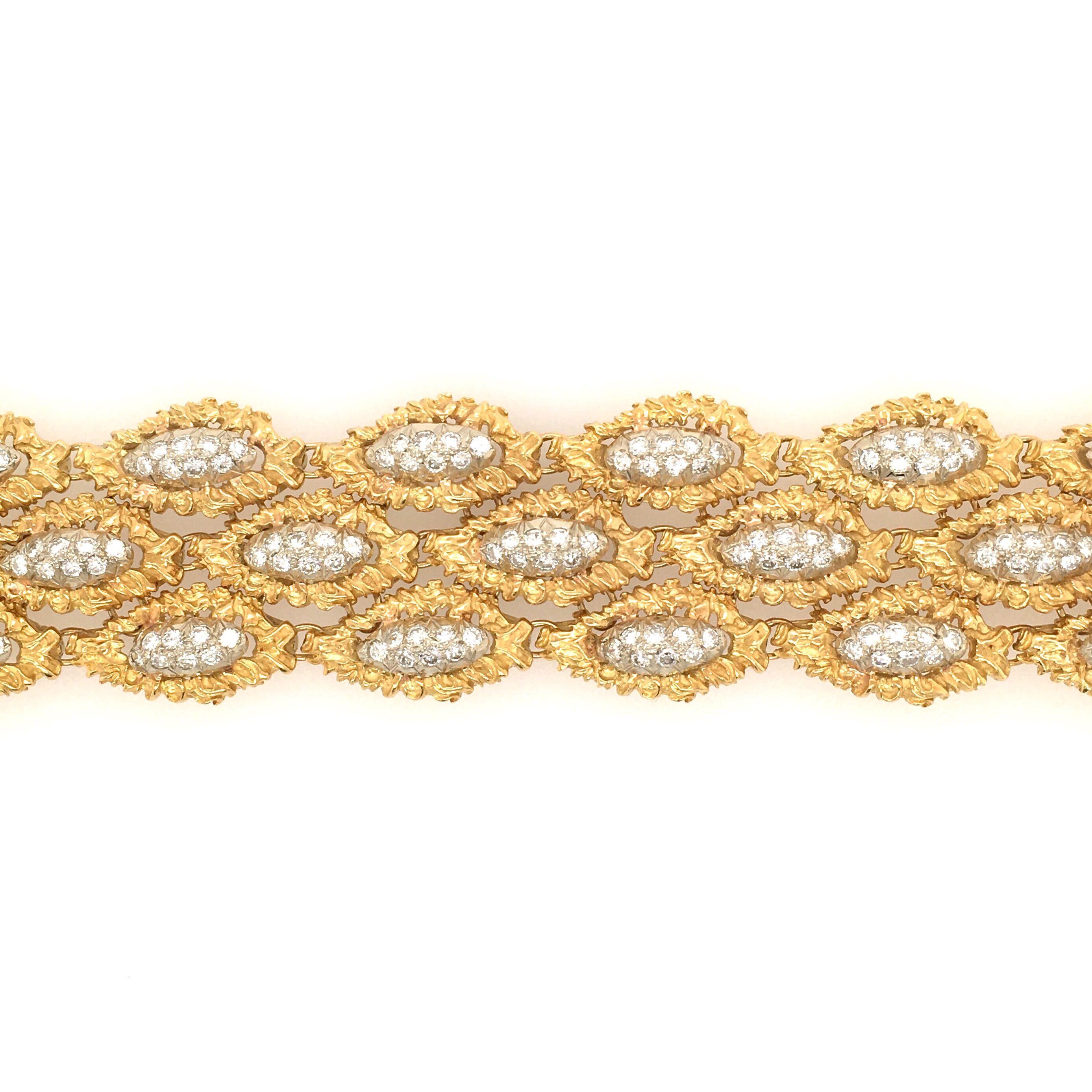 An 18 karat yellow gold and diamond bracelet.  French.  Designed as three rows of pave set navette shaped links, within textured gold  borders. Two hundred and sixteen 216 diamonds weigh 6.48 carats. Length is approximately 7 1/2 inches, gross