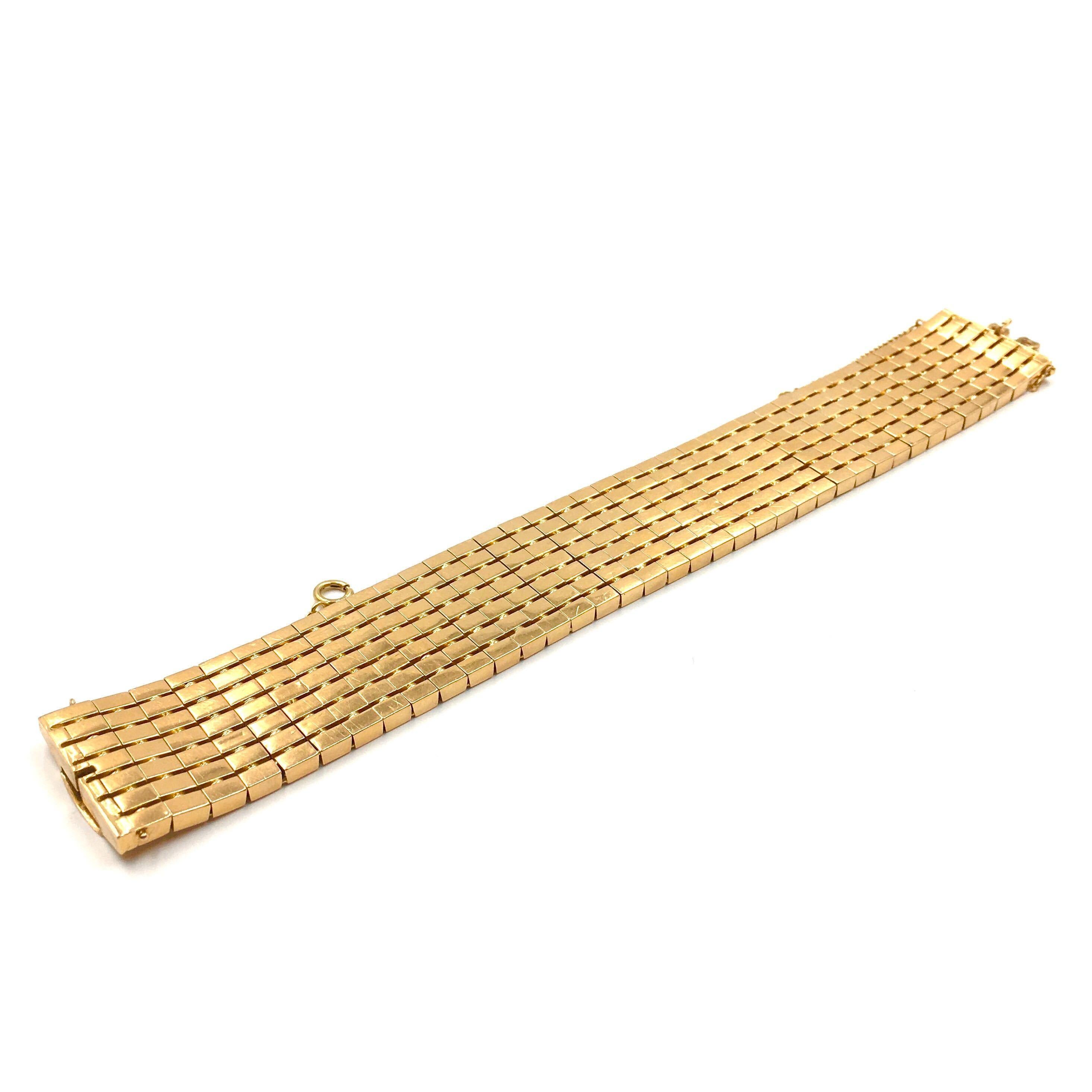 An 18 karat yellow gold bracelet.  Circa 1950.  The 1 inch wide bracelet is composed of flexibly attached small rectangular panels.  Length approximately 7 3/8 inches.  Gross weight approximately 71.9 grams.