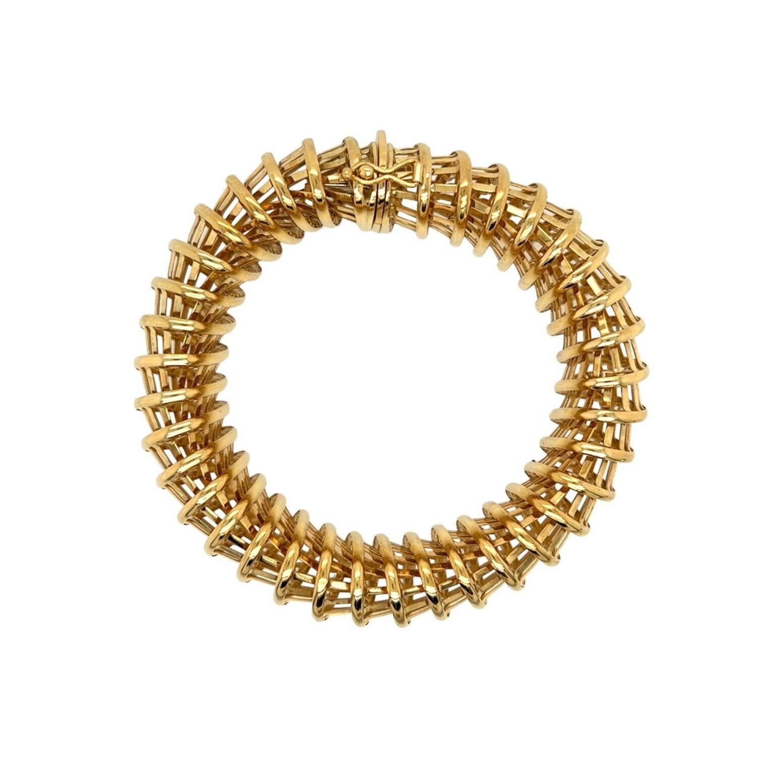 An 18 karat yellow gold bracelet, Italy.  Formed of interlocking perforated oval truncated cones forming an oval tubular bracelet.  Length approximately 7 3/4 inches.  Gross weight approximately 54.20 grams.