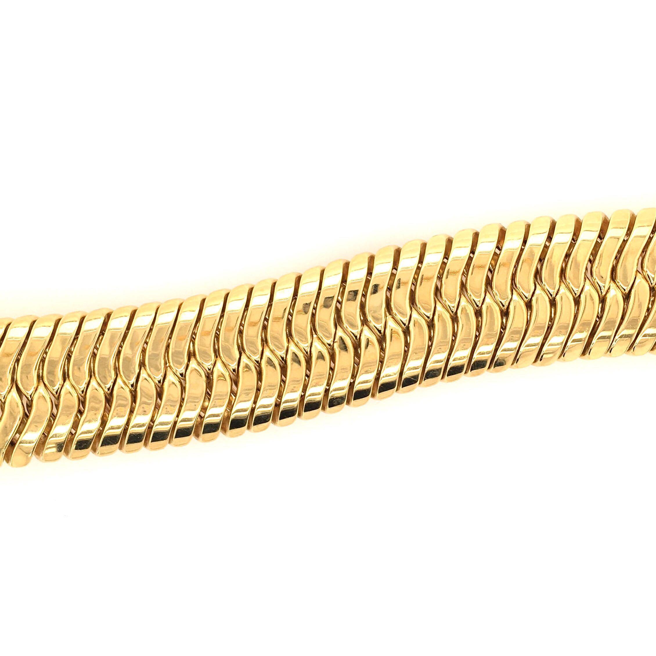 An 18 karat yellow gold bracelet. Italian. Circa 1980.    Articulated bracelet of woven braided links.   Length is approximately 8 inches. Gross weight is approximately 79 grams. Makers mark CB.