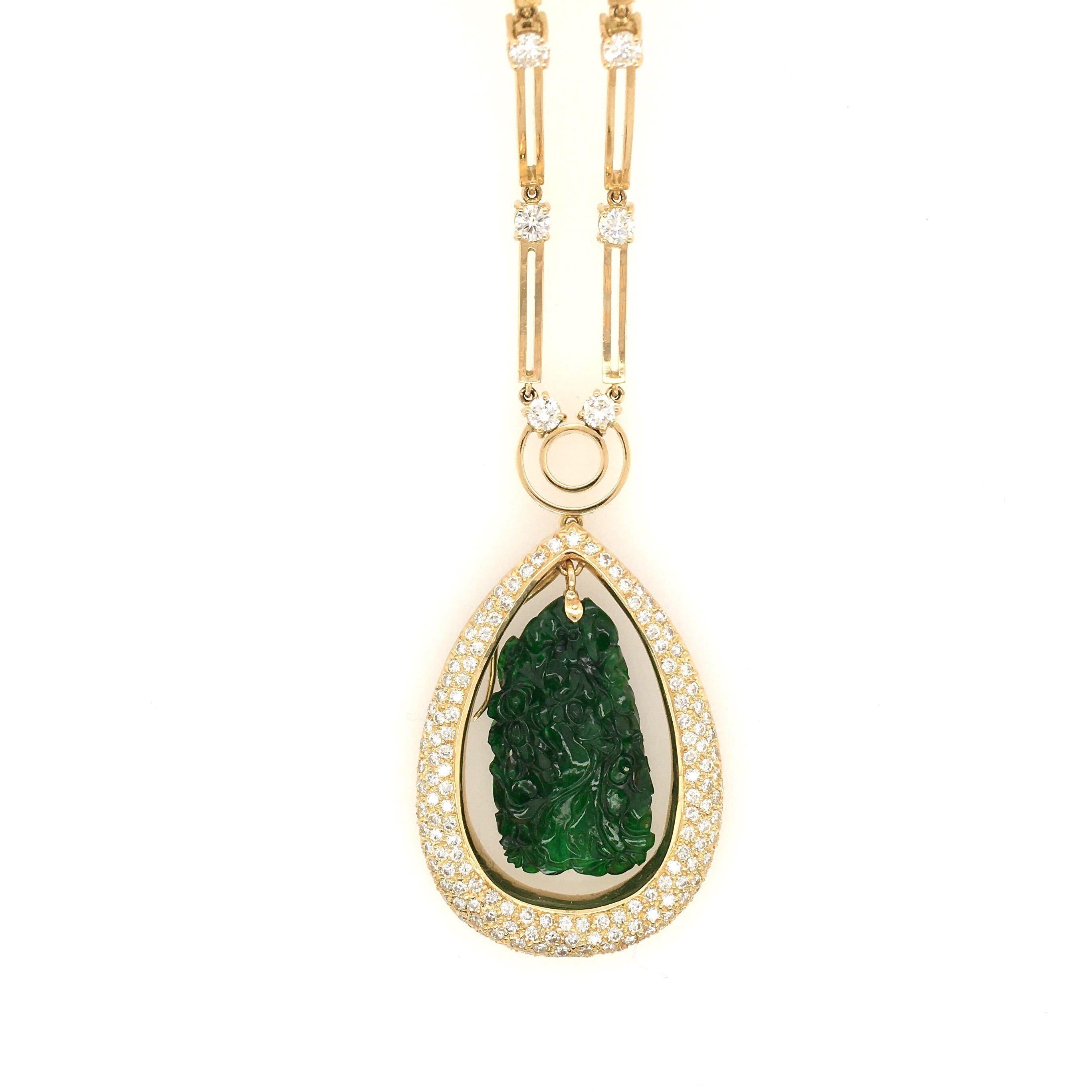 An 18 karat yellow gold, jade and diamond necklace. Suspending a rectangular carved jade plaque, measuring approximately 1 1/4 x 1/2 inch, within a pave set diamond drop shaped independent surmount, from a polished gold disc bale and rectangular