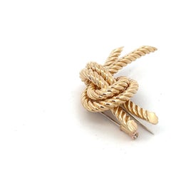 An 18 karat yellow gold knot brooch by Hermès.