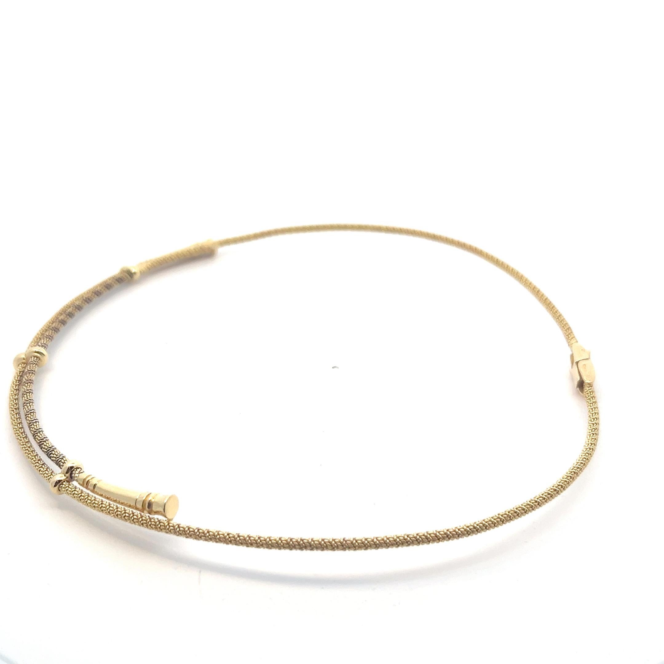 An 18 karat yellow gold and blackened yellow gold necklace by Hermès.

Origin: France.
Age: circa 1990.
Measurements: the inner diameter is circa 12.3 cm. It fit's a slim to normal sized neck.
Weight: circa 30.9 grams.
Hallmarks: Marked with the