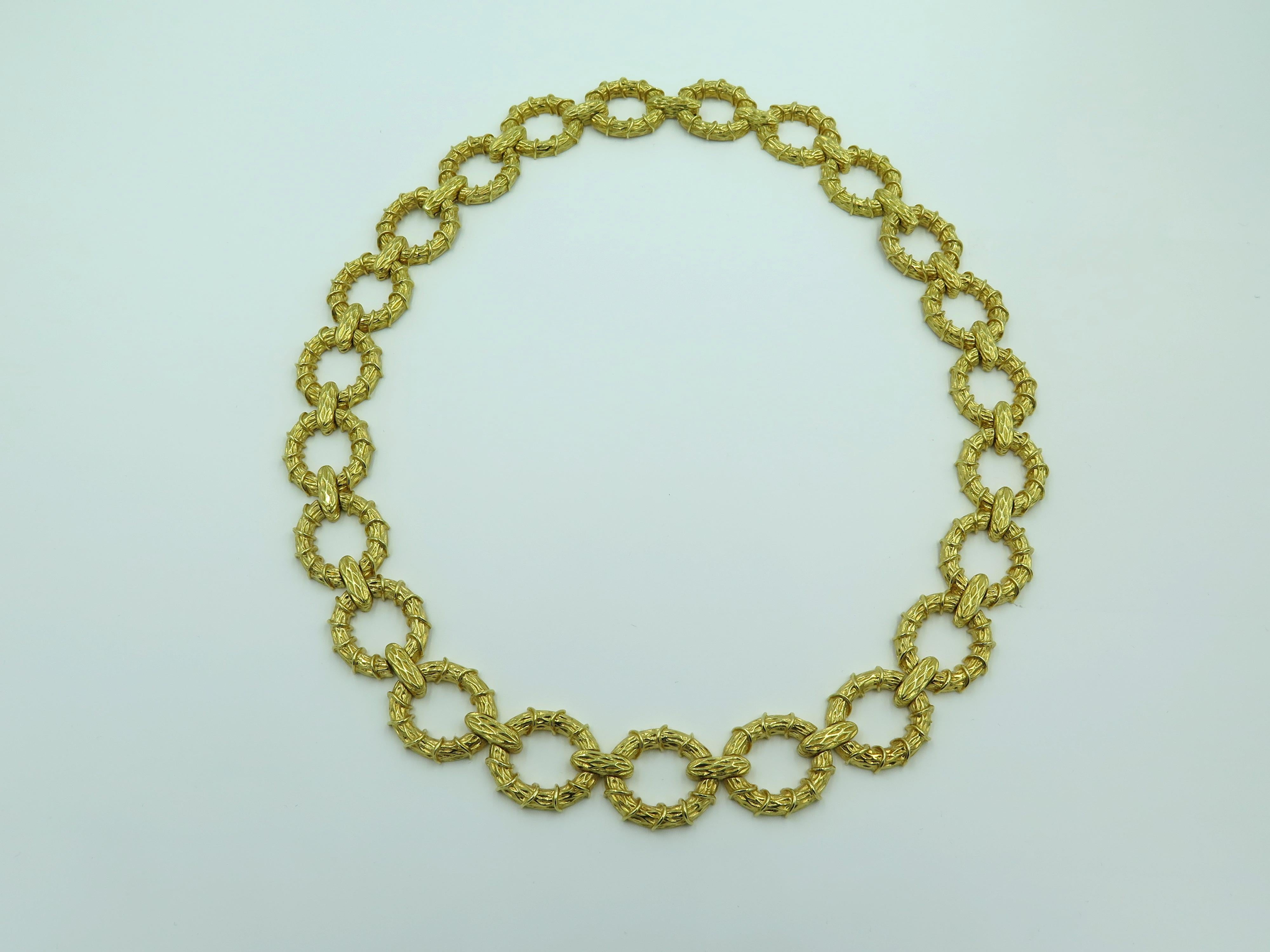 An 18 karat yellow gold necklace. Designed as textured gold oval links. Width is approximately 5/8 inches, length is approximately 19 inches, with 2 extenders, gross weight is approximately 145.3 grams.  