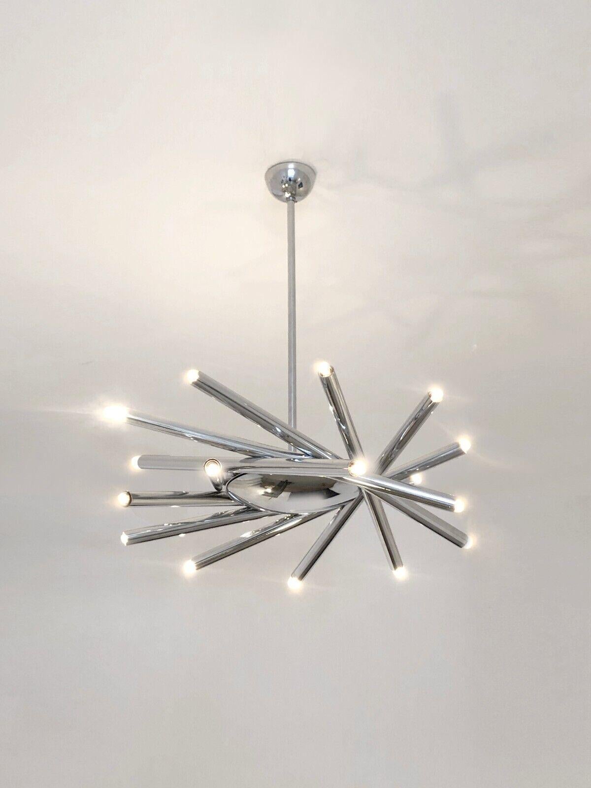 A spectacular 18-light pendant light, Radical, Post-Modernist, Space-Age, circular body surrounded by 9 long tubes or adjustable arms in chrome-plated metal with 2 lights each, the whole suspended spaceship style on a vertical axis with a spherical