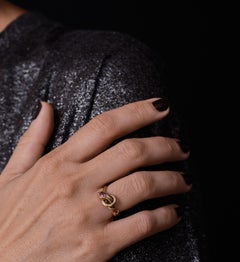 An 1890s 14K gold snake ring adorned with a ruby