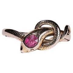 An 1890s 14K gold snake ring adorned with a ruby 