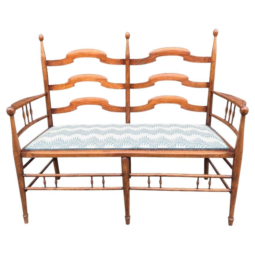 An 1890's Arts and Crafts beechwood hall seat by British designer E G Punnett