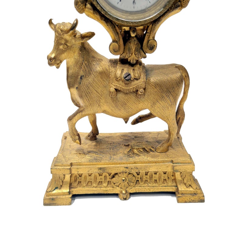 This very fine quality Neoclassical ormolu mantel clock features a highly detailed cast bronze figure of an ox supporting the body of the clock. The movement is made by Thomas Hughes, London, c. 1760, marked verso. Complete with the original