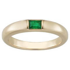An 18ct Rose Gold Token Ring Set With A Baguette Emerald