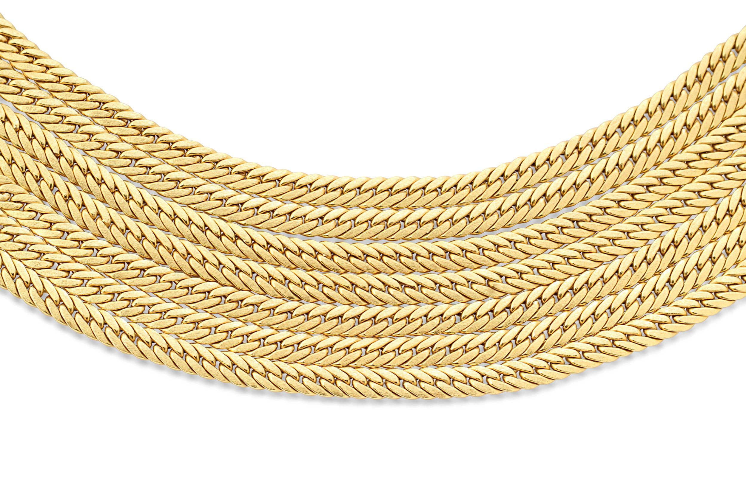 An 18k gold necklace made up of 7 rows of braided chains. The beautiful brushed finished texture combined with the braided design gives this necklace a classic stylish finish. Circa 1970s. Weight = 133.9gr.