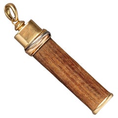 An 18k Gold and Wood Cartier Good Luck Pendant