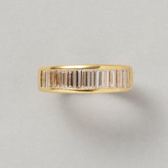 An 18k Gold Band Ring with Baguette Cut Diamonds