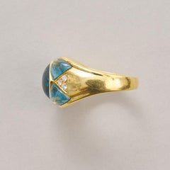 An 18k Gold Blue Topaz and Diamond Ring