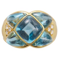 An 18k Gold Blue Topaz and Diamond Ring
