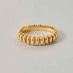 An 18k Gold Bulgari Celtaura Ribbed Bangle