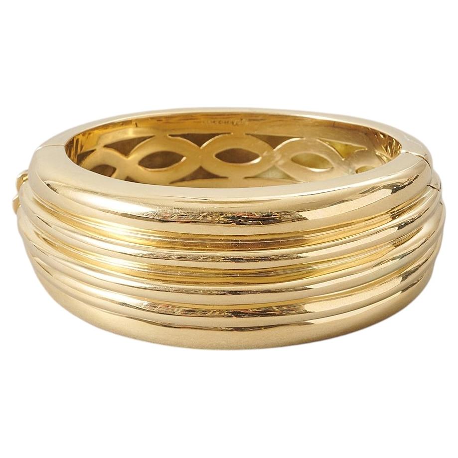 An 18k Gold Cartier Bangle